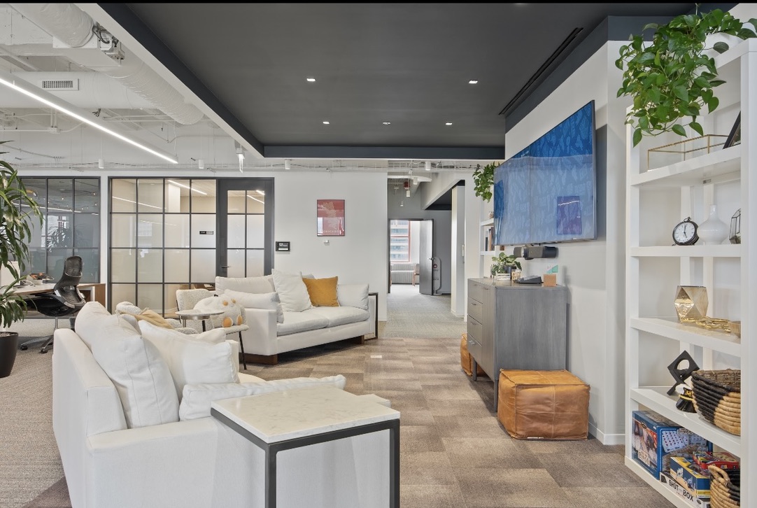 A collaborative lounge with globe pendants in a Chicago workplace